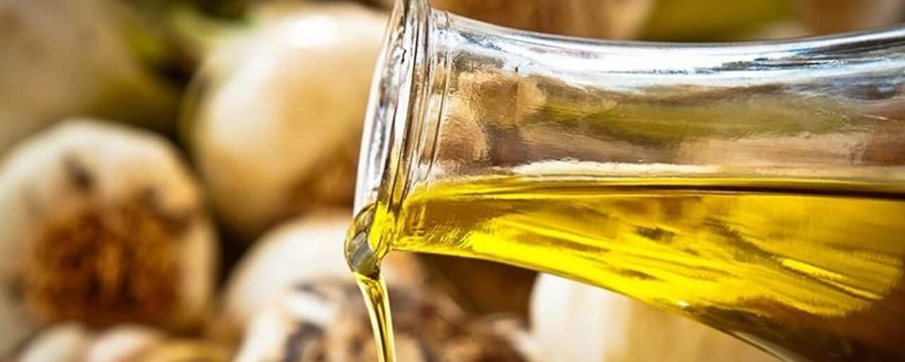 Garlic oil pouring out of a bottle