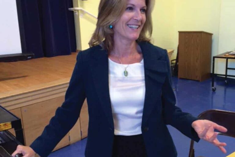 Amy Talking to Medical Staff Dr Burkhart is a celiac doctor and celiac disease specialist in suit talking to an audience