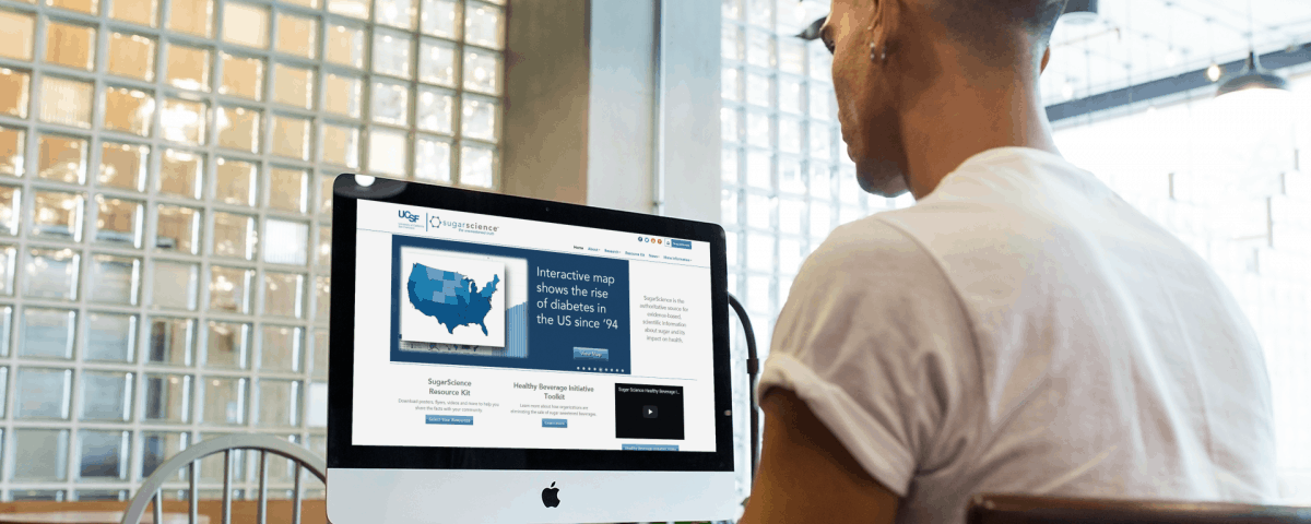 Man reading a computer looking for reliable gut health websites