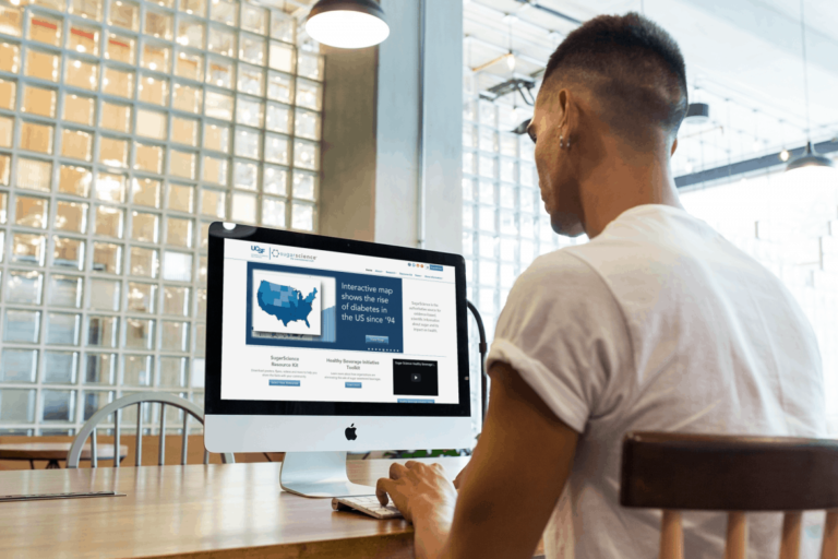 Man reading a computer looking for reliable gut health websites