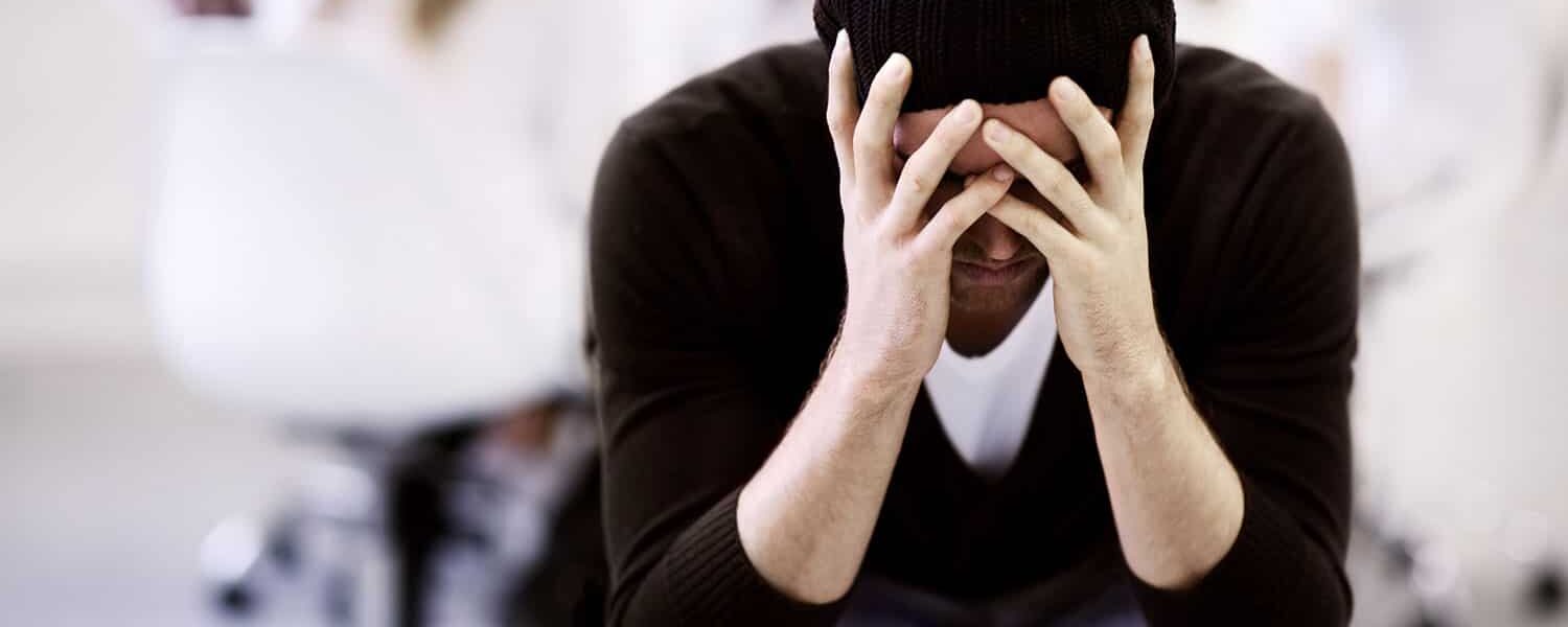 person holding head with headache vitamin A toxicity on gluten free diet