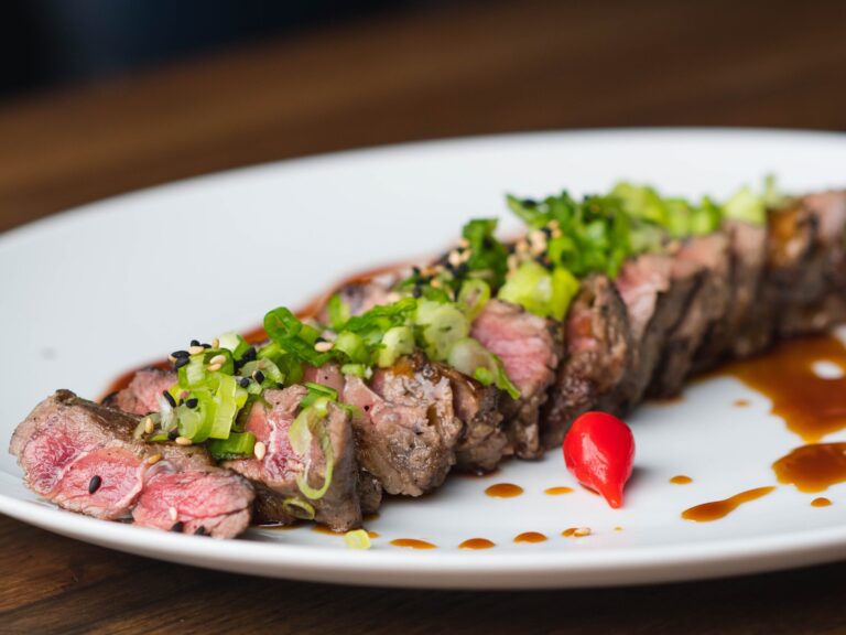 steak steak on a plate with tomato contains meat glue which may be a cause of autoimmune disease