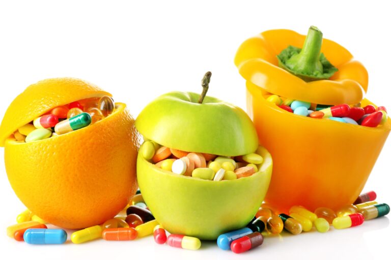 Vitamin Toxicity And Gluten Free Diet- Image is three containers that look like fruit that are overflowing with vitamins and supplements