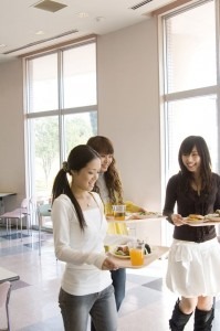 a celiac test is needed for diagnosis and disabiltiy accomodations. This is a picture of a young woman and her friends in a cafeteria at college