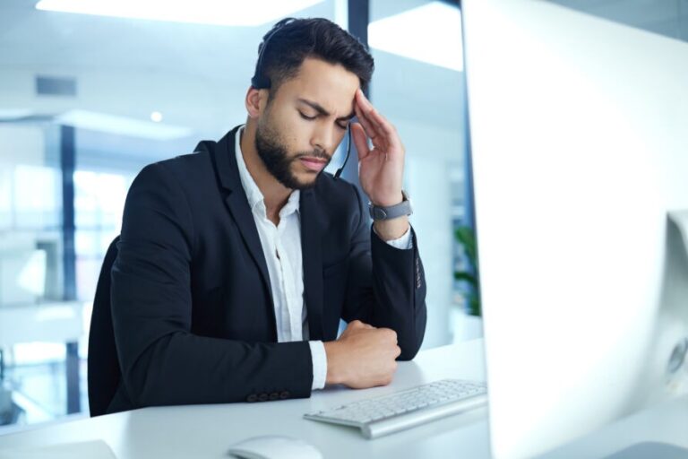 POTS tired dark skin man sitting at computer