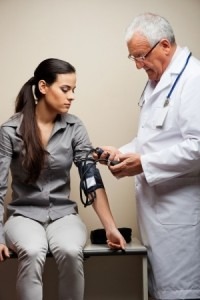 pots syndrome. Blood pressure can be very low in Pots syndrome. Image is of doctor checking a woman's blood pressure