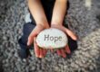 Hands holding a rock that says hope. This is to signify there is hope for people with mast cell activation disorder, also known as MCAS