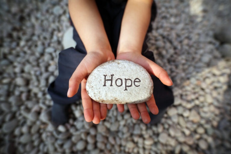 Hands holding a rock that says hope. This is to signify there is hope for people with mast cell activation disorder, also known as MCAS