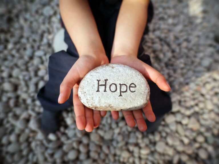 Hands holding a rock that says hope. This is to signify there is hope for people with mast cell activation disorder, also known as MCAS