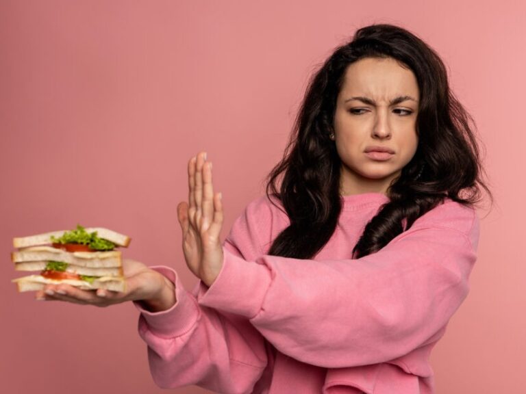 arfid in adults is on the rise. arfid symptoms and arfid treatement are explained. Image is of a woman refusing food