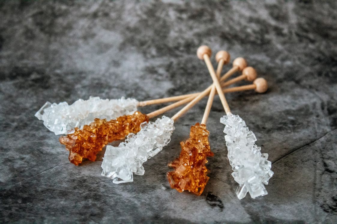 Rock sugar on wooden sticks. This can make sucrose intolerance symptoms worse