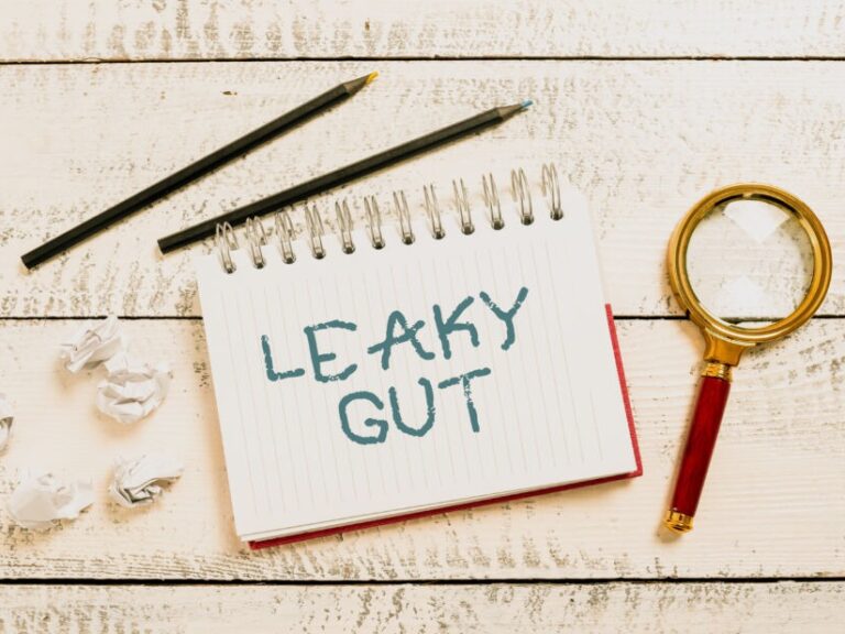 Text showing inspiration Leaky Gut. Conceptual photo A condition in which the lining of small intestine is damaged -48250 Image is words leaky gut on a notepad with a magnifying glass. A leaky gut diet differs depending on who you talke to