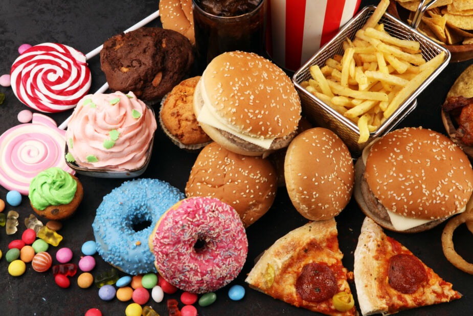 nhealthy products. food bad for figure, skin, heart and teeth. Assortment of fast carbohydrates food with fries and cola. A leaky gut diet is not a diet containing processed foods which can actually cause leaky gut