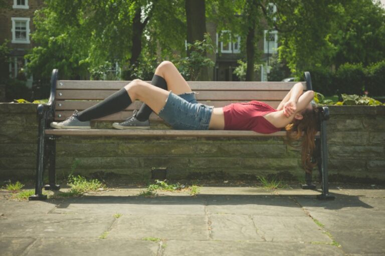POTS and gluten. A young woman lies on a bench wearing compression stockings. A gluten free diet may help pots