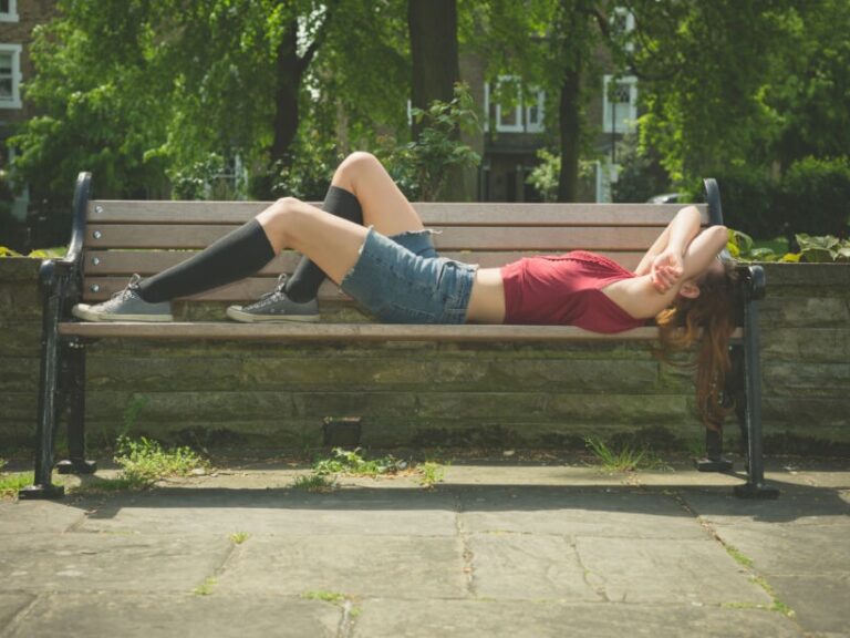 POTS and gluten. A young woman lies on a bench wearing compression stockings. A gluten free diet may help pots