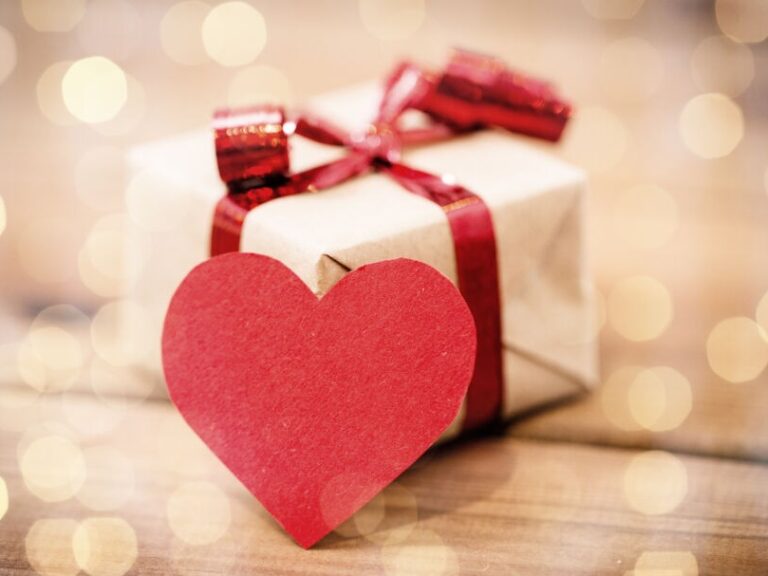 Unique gluten free gifts can come in any shape, size or idea. This is a picture of a box wrapped wtih red ribbon and with a heart in front of it